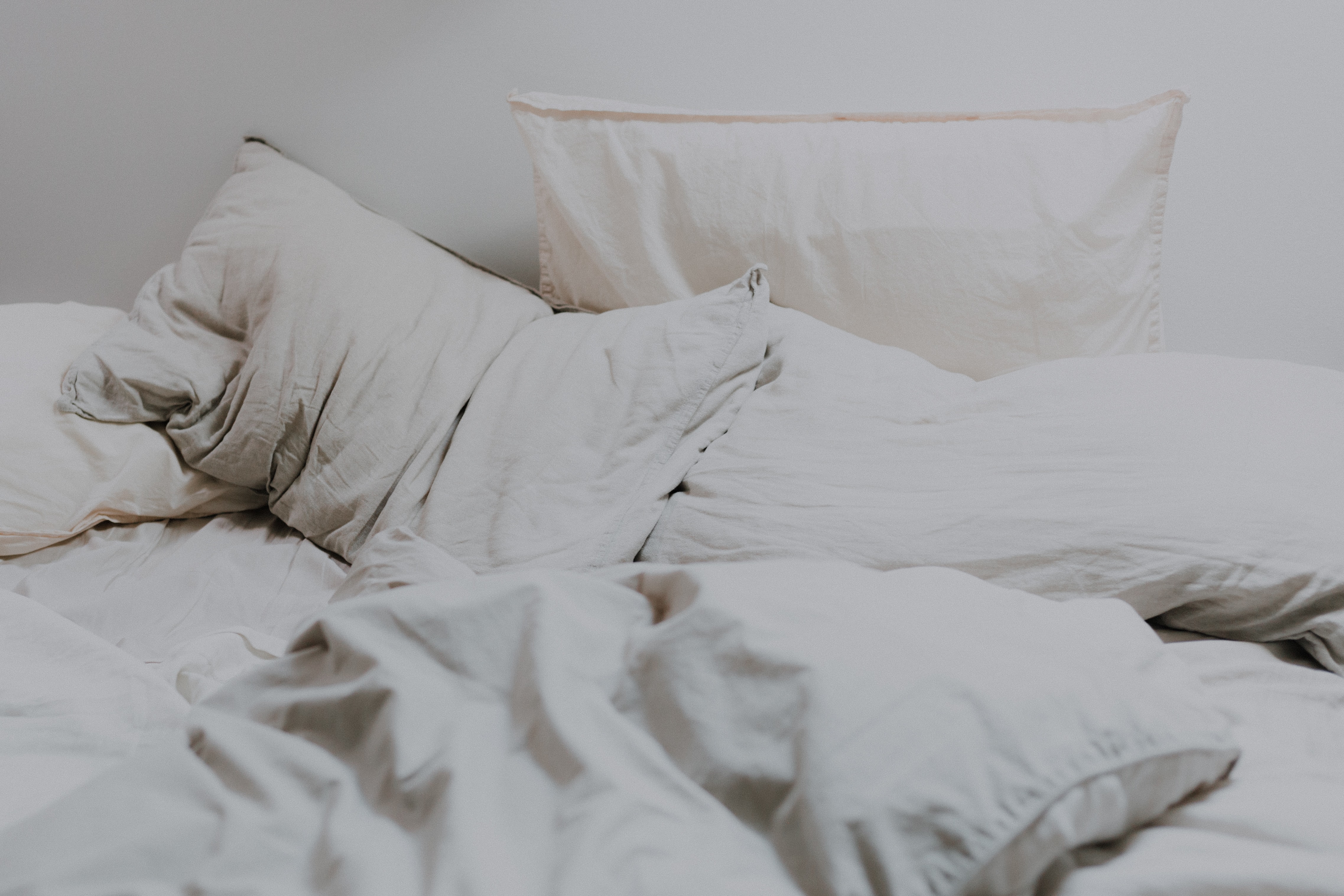 Cama sin hacer con almohadas desordenadas