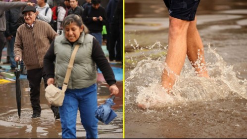 Personas cruzando el agua luego de las intensas lluvias de la semana pasada.